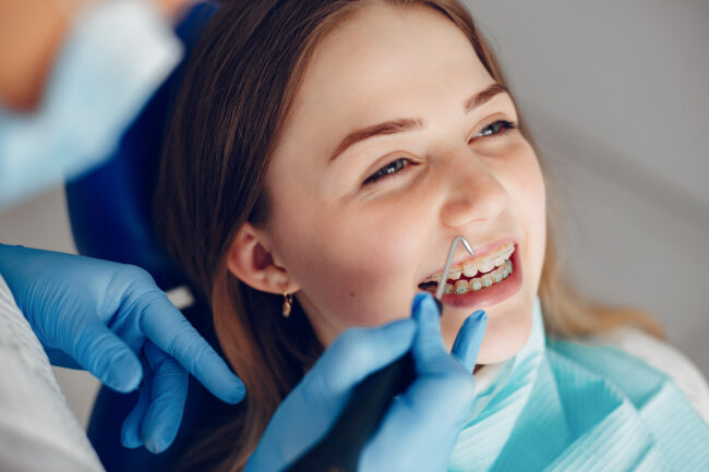 Beautiful girl sitting in the dentist’s office